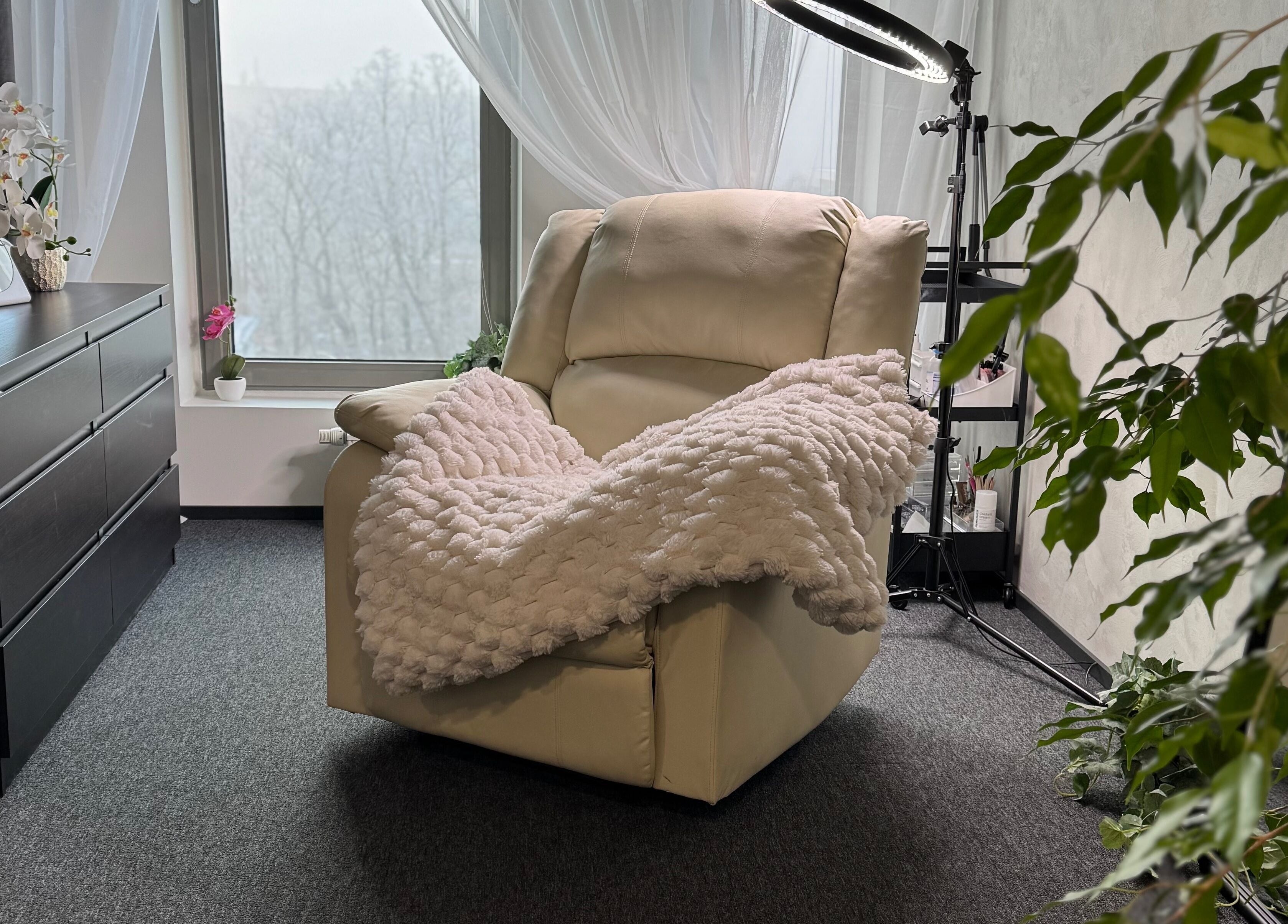 Relaxing white armchair with plush throw at Lashhaus Tallinn, Tallinn, Harju maakond, EE.
