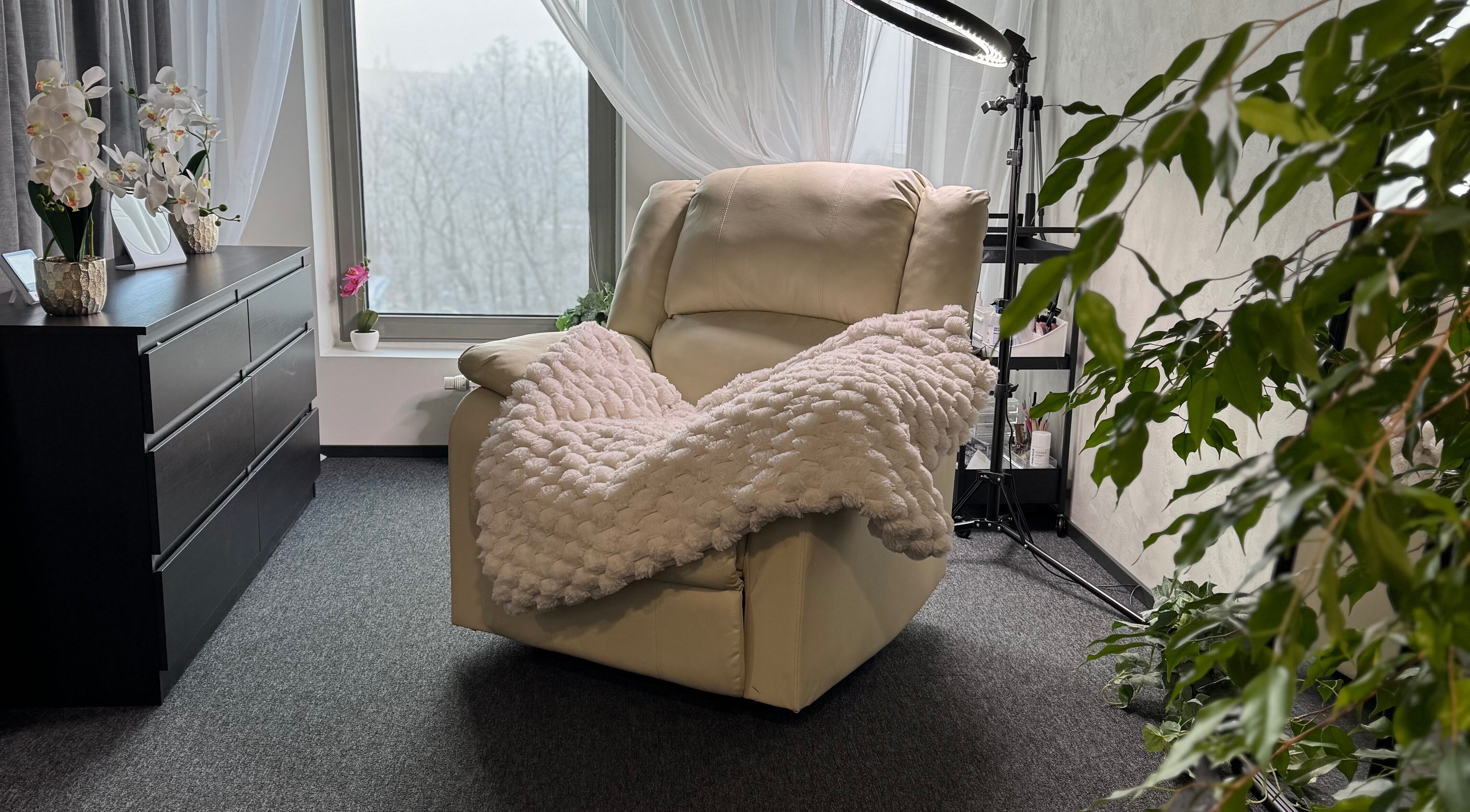 Relaxing white armchair with plush throw at Lashhaus Tallinn, Tallinn, Harju maakond, EE.