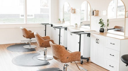Rosie Atkins Hair salon interior in Winston-Salem, North Carolina, US showcasing stylish chairs and modern decor.