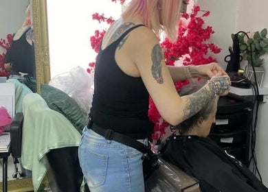 Stylist at Tash @ studio210 in Nottingham, England, GB, creating a chic hairstyle in a modern salon.