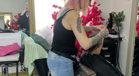 Stylist at Tash @ studio210 in Nottingham, England, GB, creating a chic hairstyle in a modern salon.