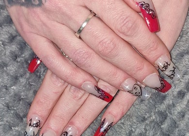 Detailed nail art showcasing red and white designs at Stained Beauty Co, Arnold, England, GB.