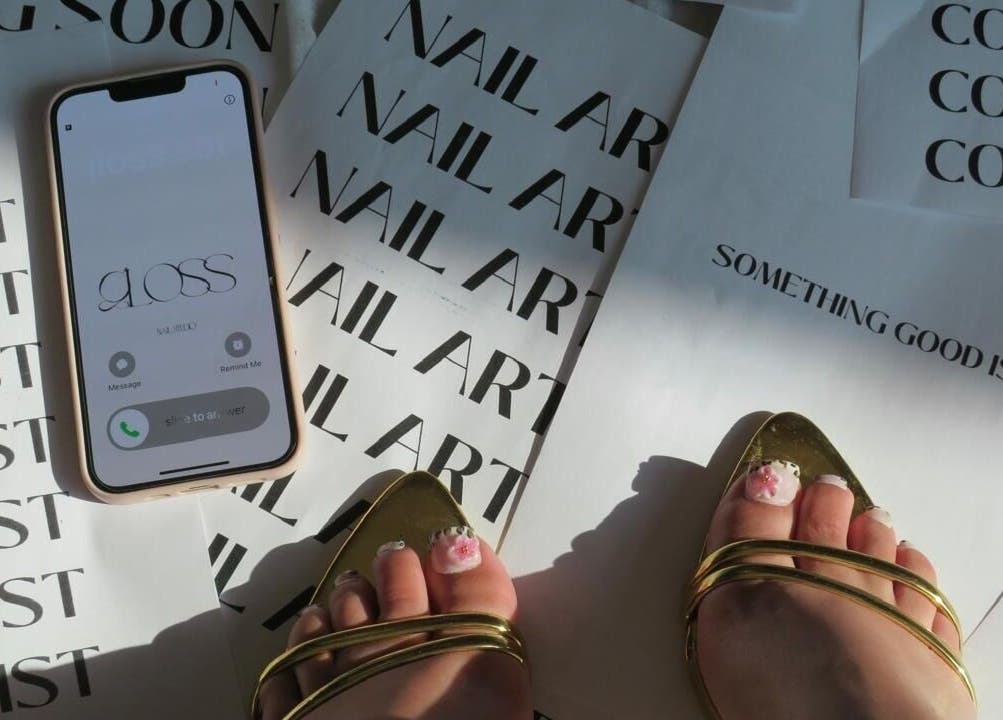 Gloss Sets by Cay in Gqeberha, Eastern Cape, ZA features elegant nail art and gold sandals.