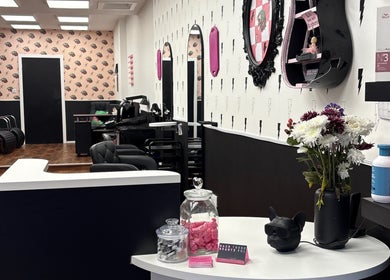 Interior of Hair There Jennifer salon in Inverness, Scotland, GB, showcasing chic decor and modern styling chairs.