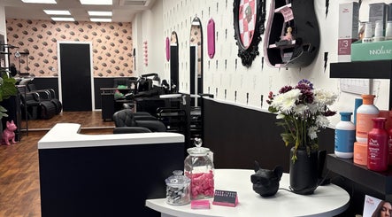 Interior of Hair There Jennifer salon in Inverness, Scotland, GB, showcasing chic decor and modern styling chairs.