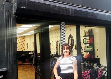Entrance of Hair There Jennifer in Inverness, Scotland, GB with welcoming staff member.