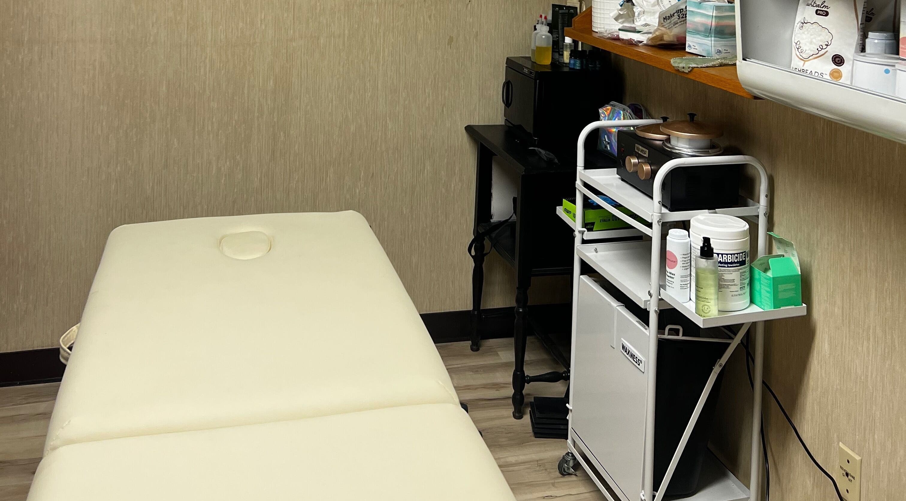 Peaceful treatment room at Bare & Bougie LLC, Oskaloosa, Iowa, US featuring a comfortable massage table.