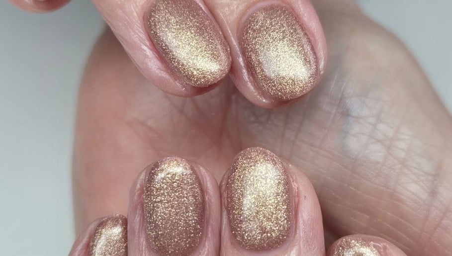 Elegant gold glitter manicure at The Beauty Basement, Pudsey, England, GB, showcasing expert nail artistry.