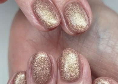 Elegant gold glitter manicure at The Beauty Basement, Pudsey, England, GB, showcasing expert nail artistry.