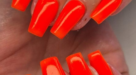 Bright orange nails at The Beauty Basement in Pudsey, England, GB showcasing vibrant manicure style.