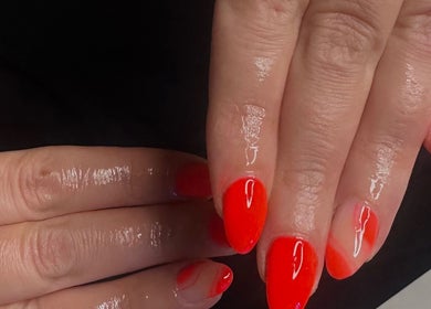Vibrant red manicure at The Beauty Basement, Pudsey, England, GB. Perfectly polished nails.