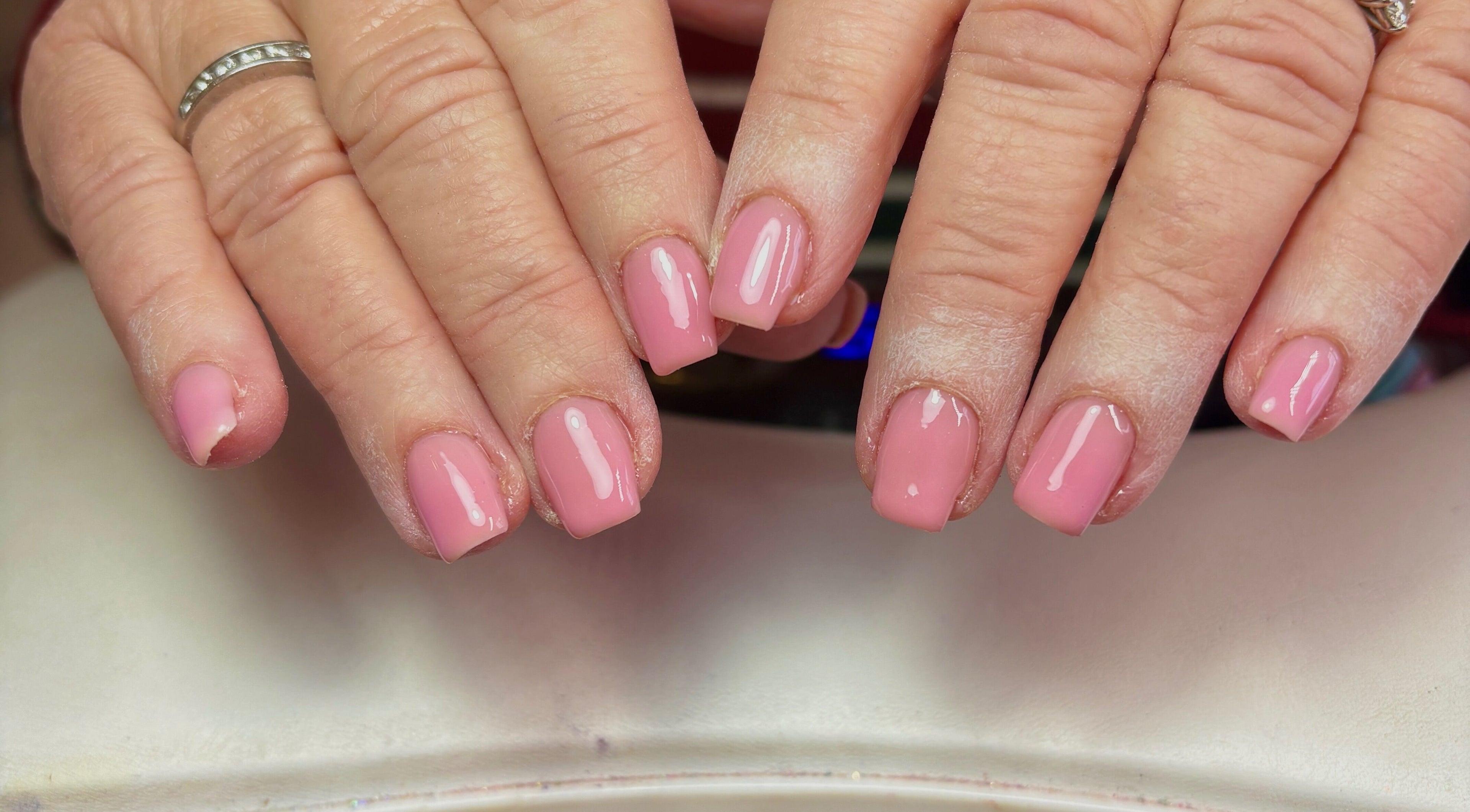 Manicured pink nails at Ellavated Nailz, Cardiff, Wales, GB showcasing expert nail art.