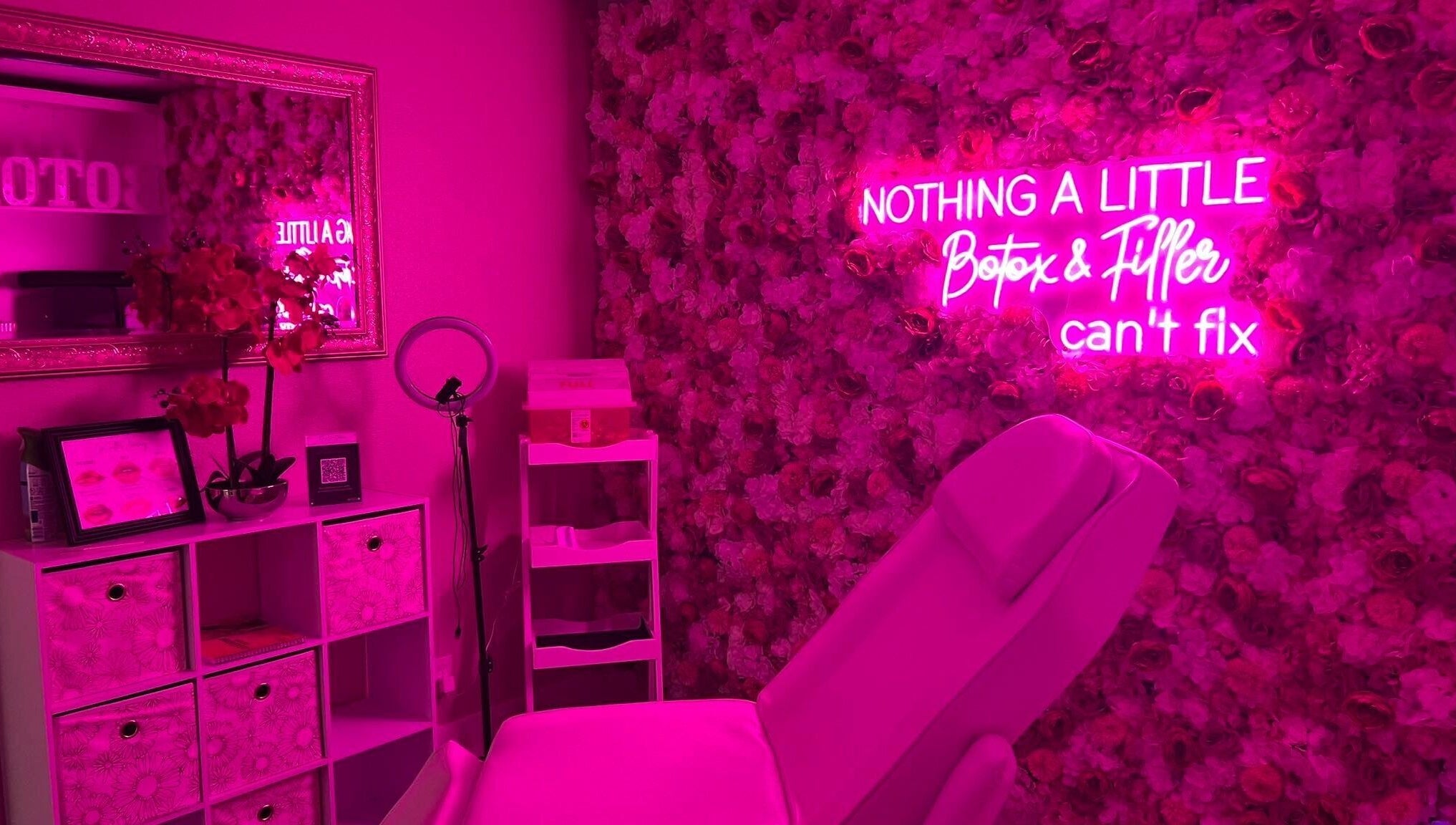 Elegant pink spa room with neon sign at Sharp Shots Academy & Spa, San Antonio, Texas, US.