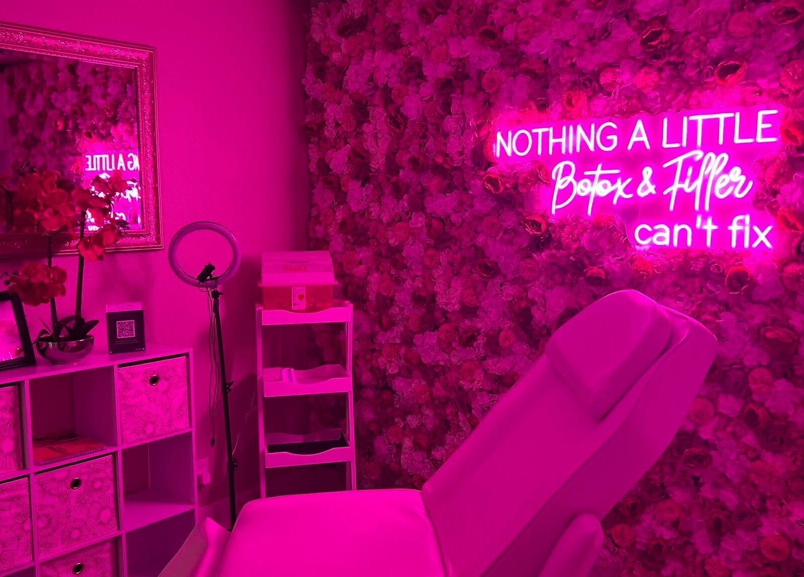Elegant pink spa room with neon sign at Sharp Shots Academy & Spa, San Antonio, Texas, US.