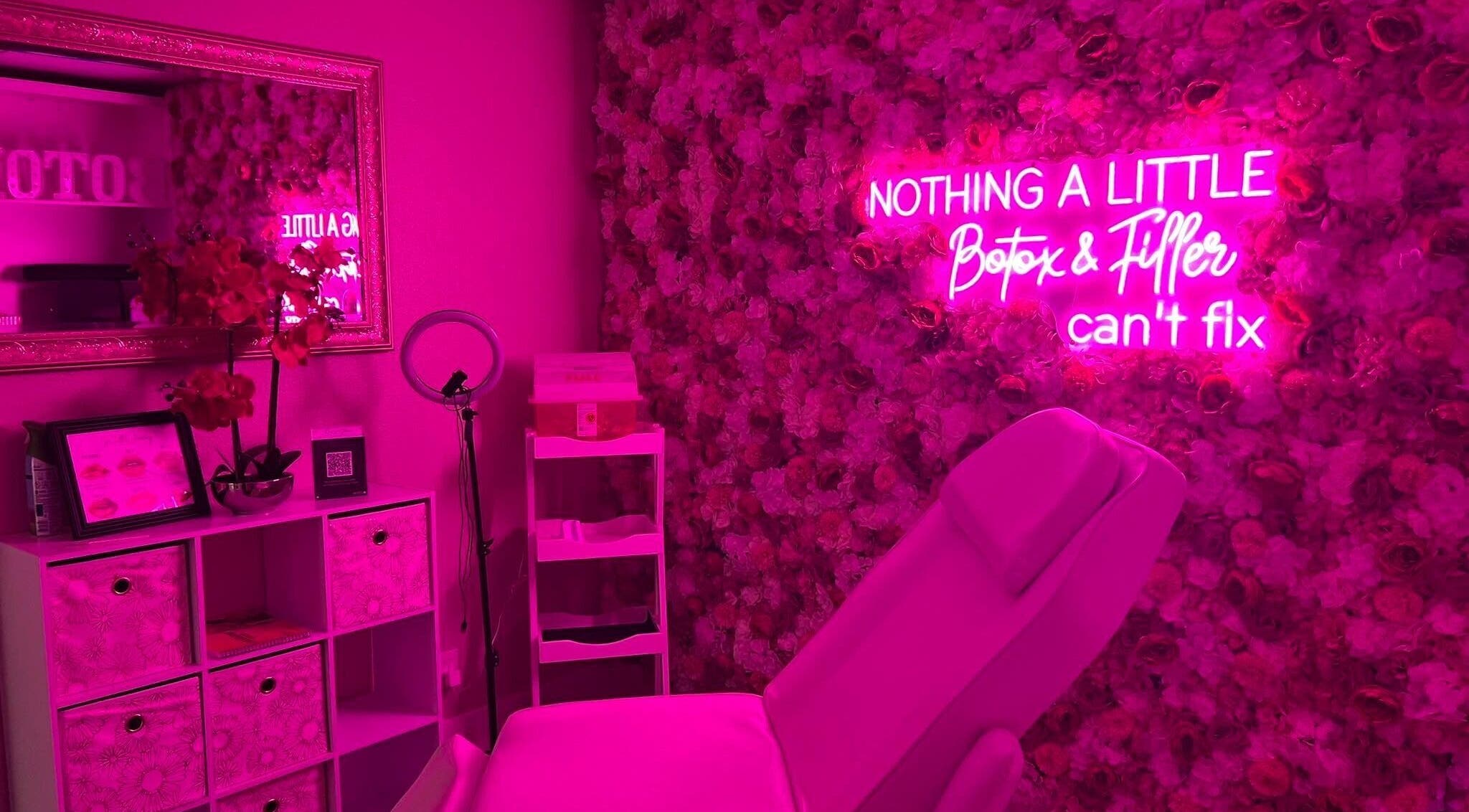 Elegant pink spa room with neon sign at Sharp Shots Academy & Spa, San Antonio, Texas, US.
