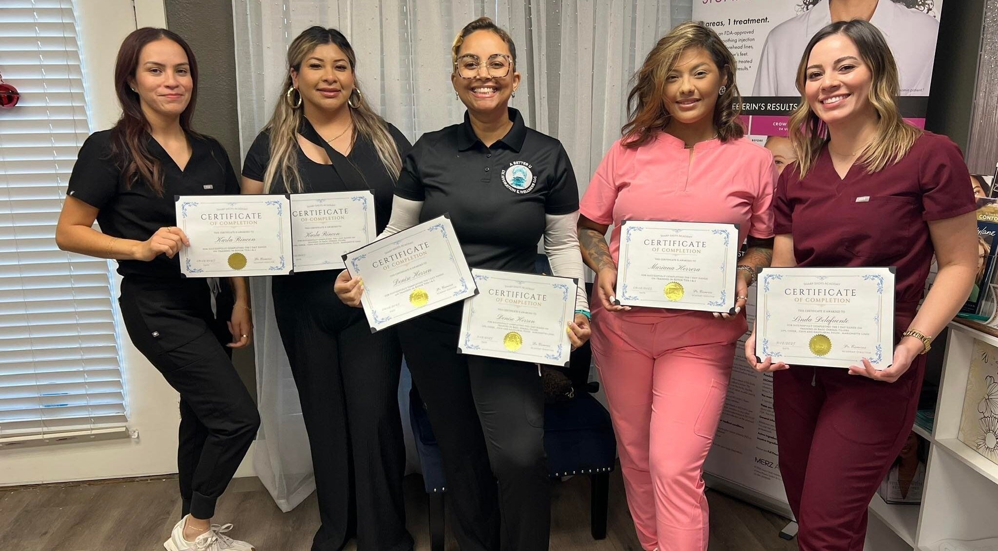 Graduates holding certificates at Sharp Shots Academy & Spa in San Antonio, Texas, US.