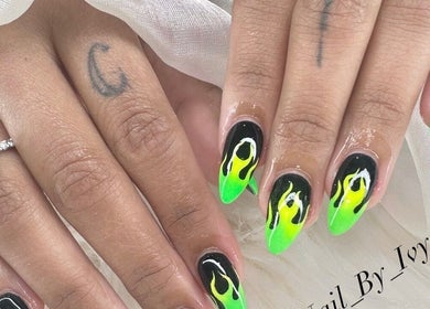 Vibrant flame nail design at Nailvana, Cincinnati, Ohio, US. Stunning green and black manicure art.