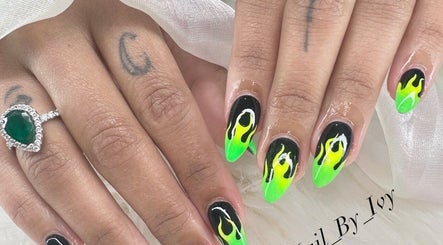 Vibrant flame nail design at Nailvana, Cincinnati, Ohio, US. Stunning green and black manicure art.