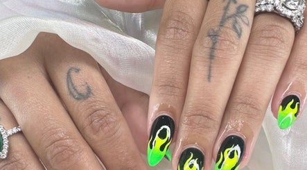 Vibrant flame nail art at Nailvana, Cincinnati, Ohio, US, showcasing intricate black and green designs.