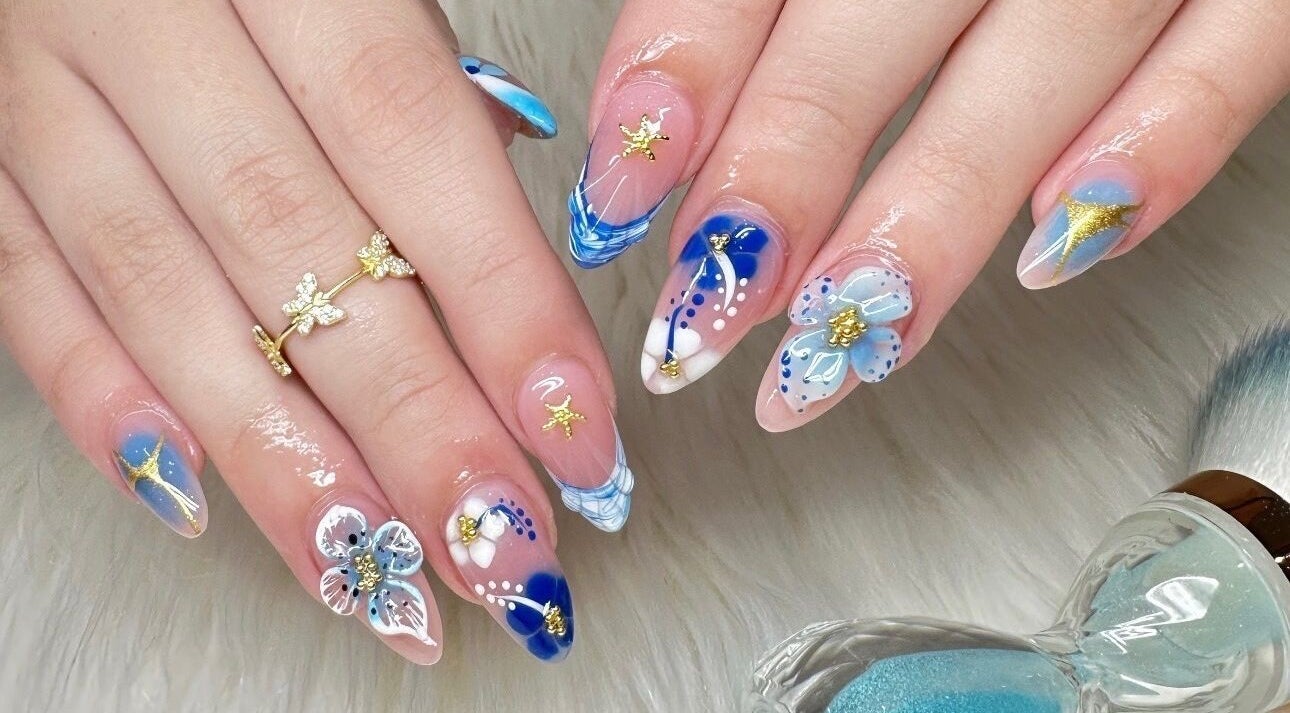 Stylish blue flower nail art at Nailvana, Cincinnati, Ohio, US.