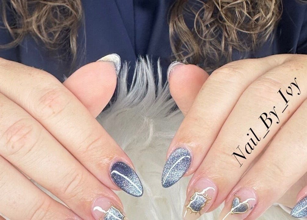 Stylish glitter nails design at Nailvana, Cincinnati, Ohio, US showcasing blue and silver sparkle.