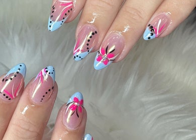 Stunning floral nail art in blue and pink at Nailvana, Cincinnati, Ohio, US.