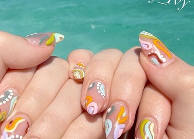 Colorful nail art with swirls at Nailvana, Cincinnati, Ohio, US. Showcasing unique and trendy designs.