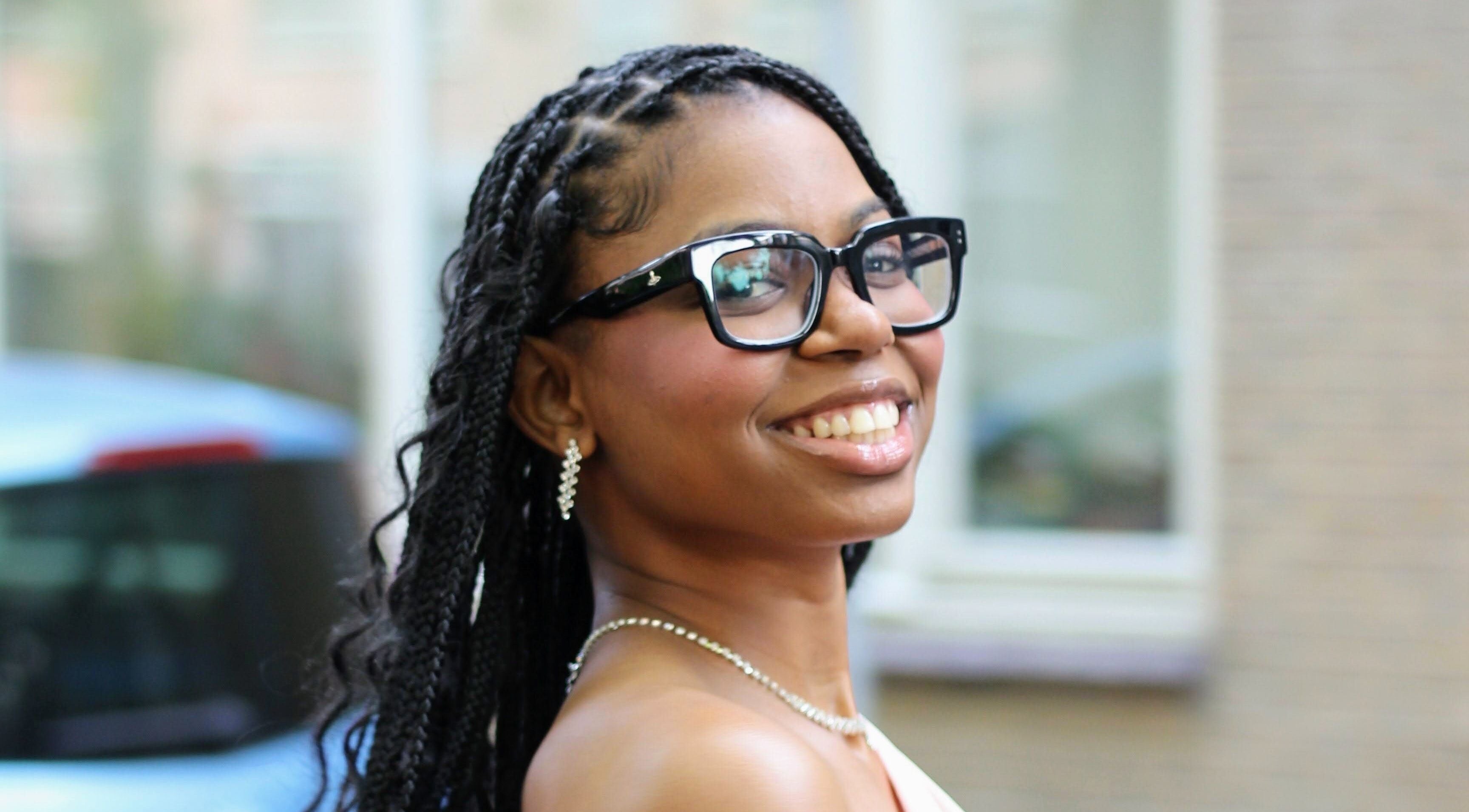 Woman smiling gracefully near Nevia Glam, NL, showcasing elegance and style.