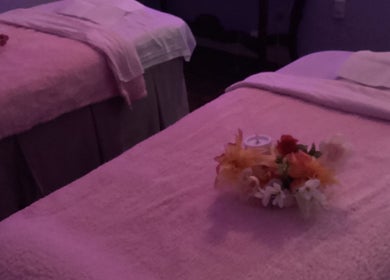 Relaxing massage tables at Lido Massage, Gainesville, Georgia, US, with soft lighting and floral arrangements.
