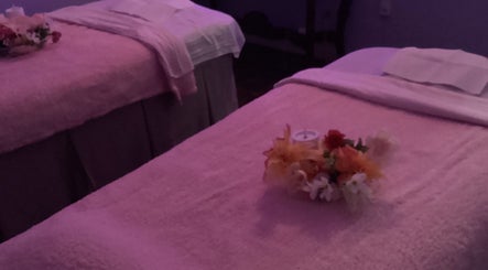 Relaxing massage tables at Lido Massage, Gainesville, Georgia, US, with soft lighting and floral arrangements.