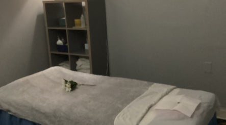 Calm massage room at Lido Massage in Gainesville, Georgia, US, featuring a cozy table with soft linens.