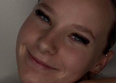 Smiling person showcasing lash extensions at Lasheddbymkk, Melonba, New South Wales, AU.
