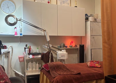 Cozy treatment room at The Beauty Room, Singapore, SG, featuring spa essentials and ambient lighting.