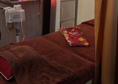 Massage bed setup at The Beauty Room, Singapore, Singapore, SG with warm lighting and a floral towel.