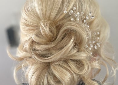 Elegant blonde updo with pearl accents by Styled by Jenna, Blantyre, Scotland, GB. Perfect for special occasions.