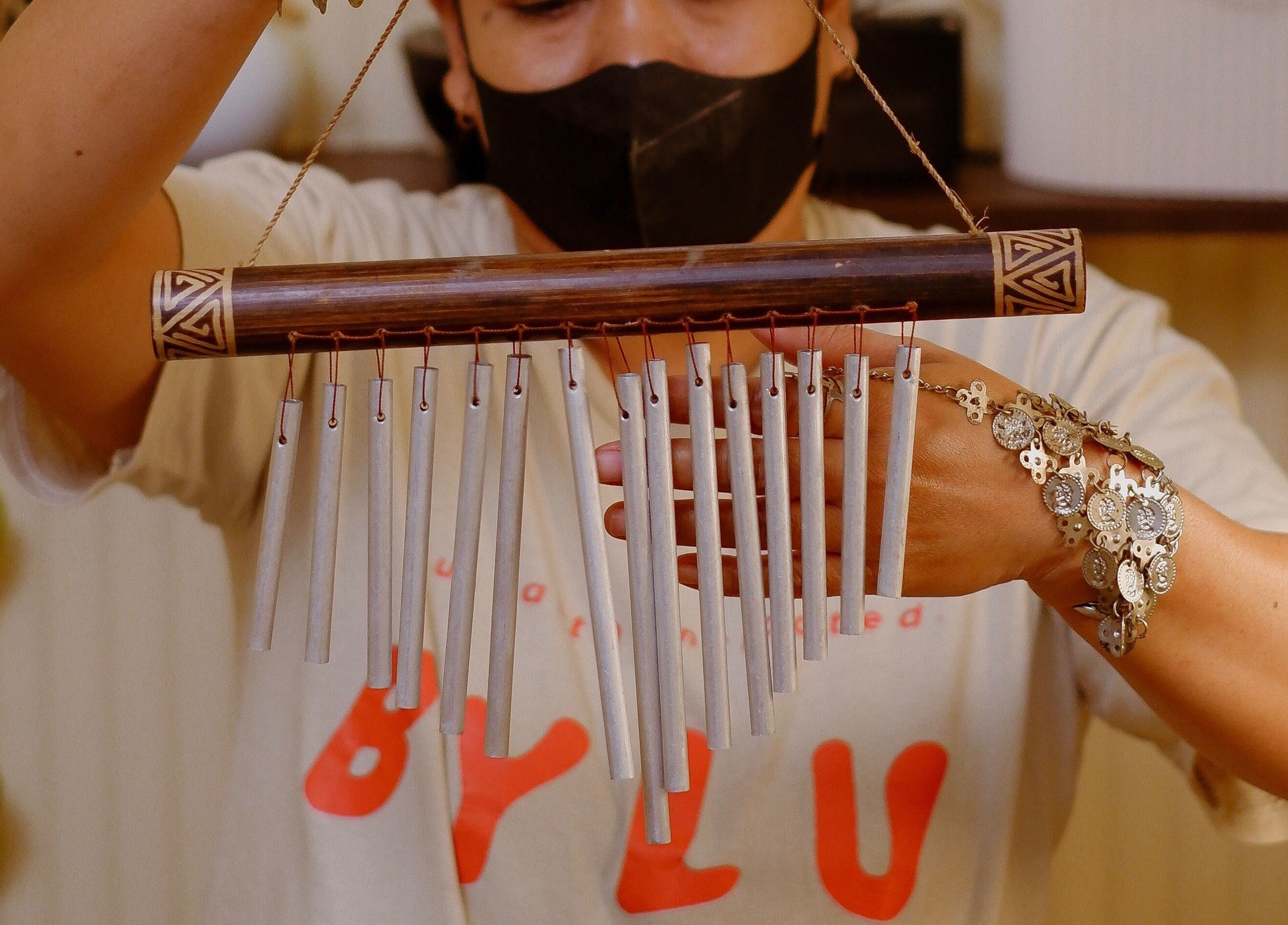 Person holding decorative chimes at BYLU Scalp & Body Spa, Daerah Istimewa Yogyakarta, ID.