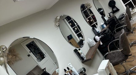 Interior of Coa hair salon in York, England, GB, featuring modern styling chairs and elegant mirrors.