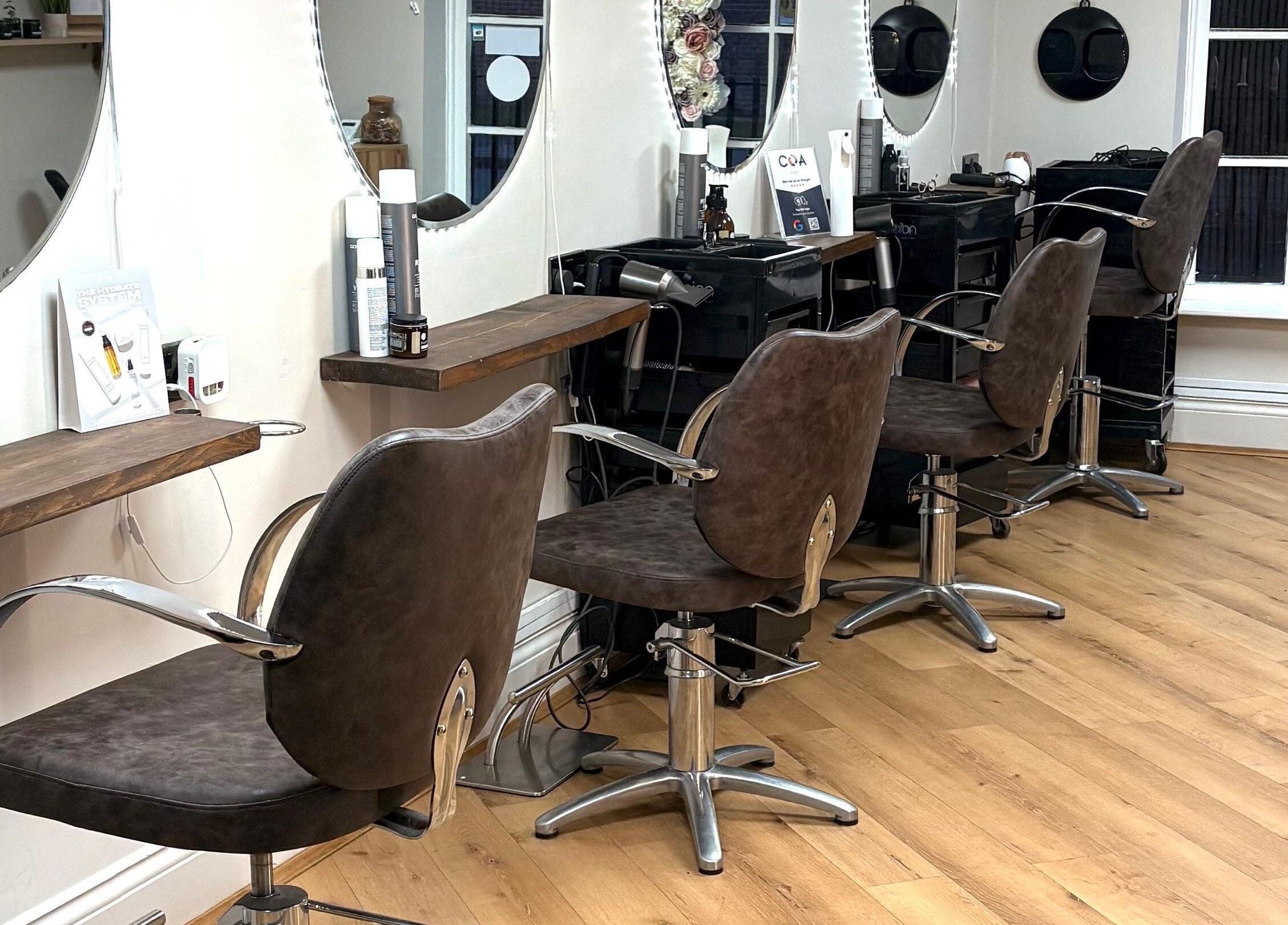 Chic salon chairs inside Coa Hair, York, England, GB, reflecting a modern beauty experience.