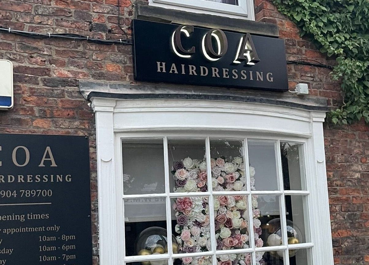 Coa Hair storefront in York, England, GB, featuring elegant signage and floral window display.