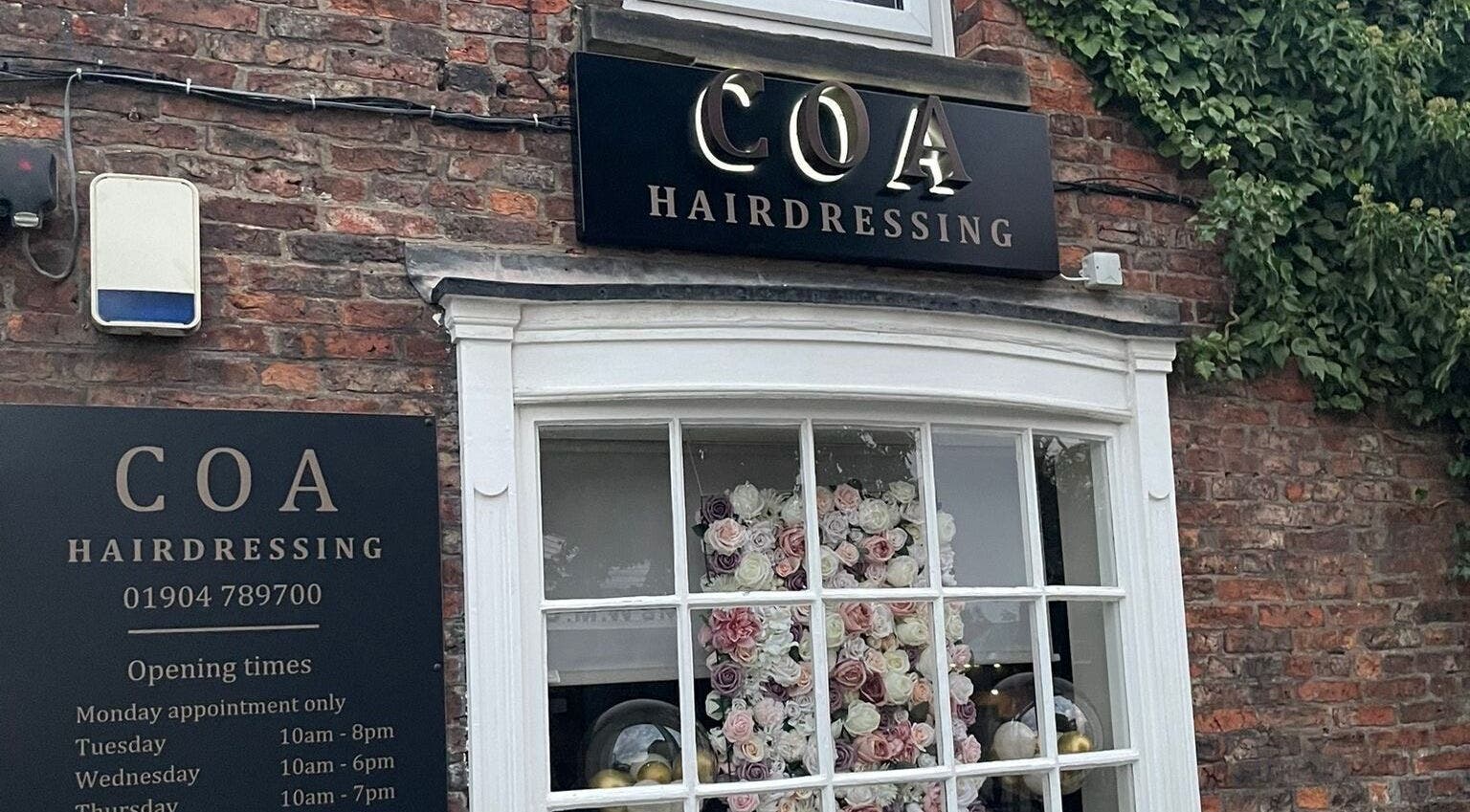 Coa Hair storefront in York, England, GB, featuring elegant signage and floral window display.