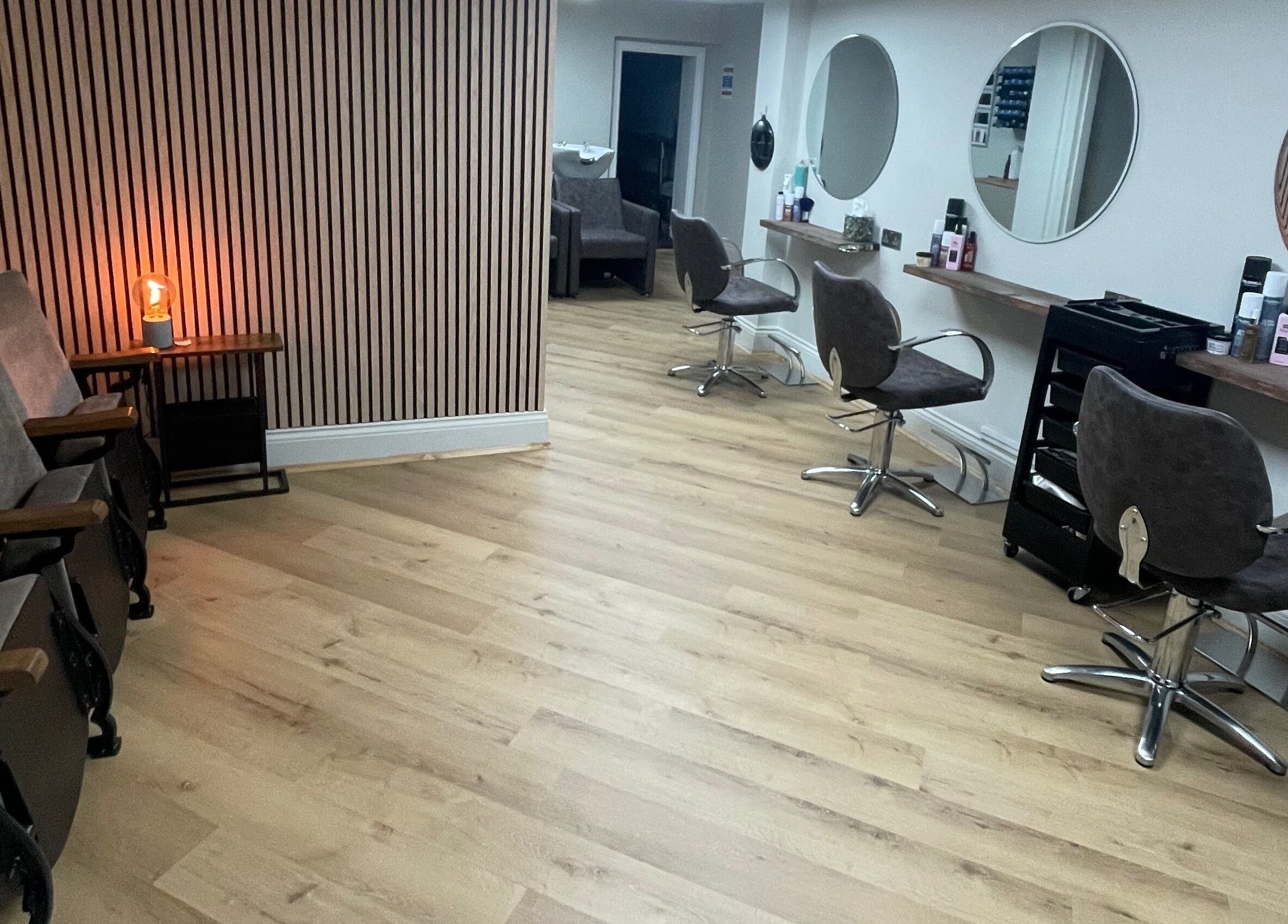 Modern salon interior at Coa Hair, York, England, GB featuring stylish chairs and mirrors.
