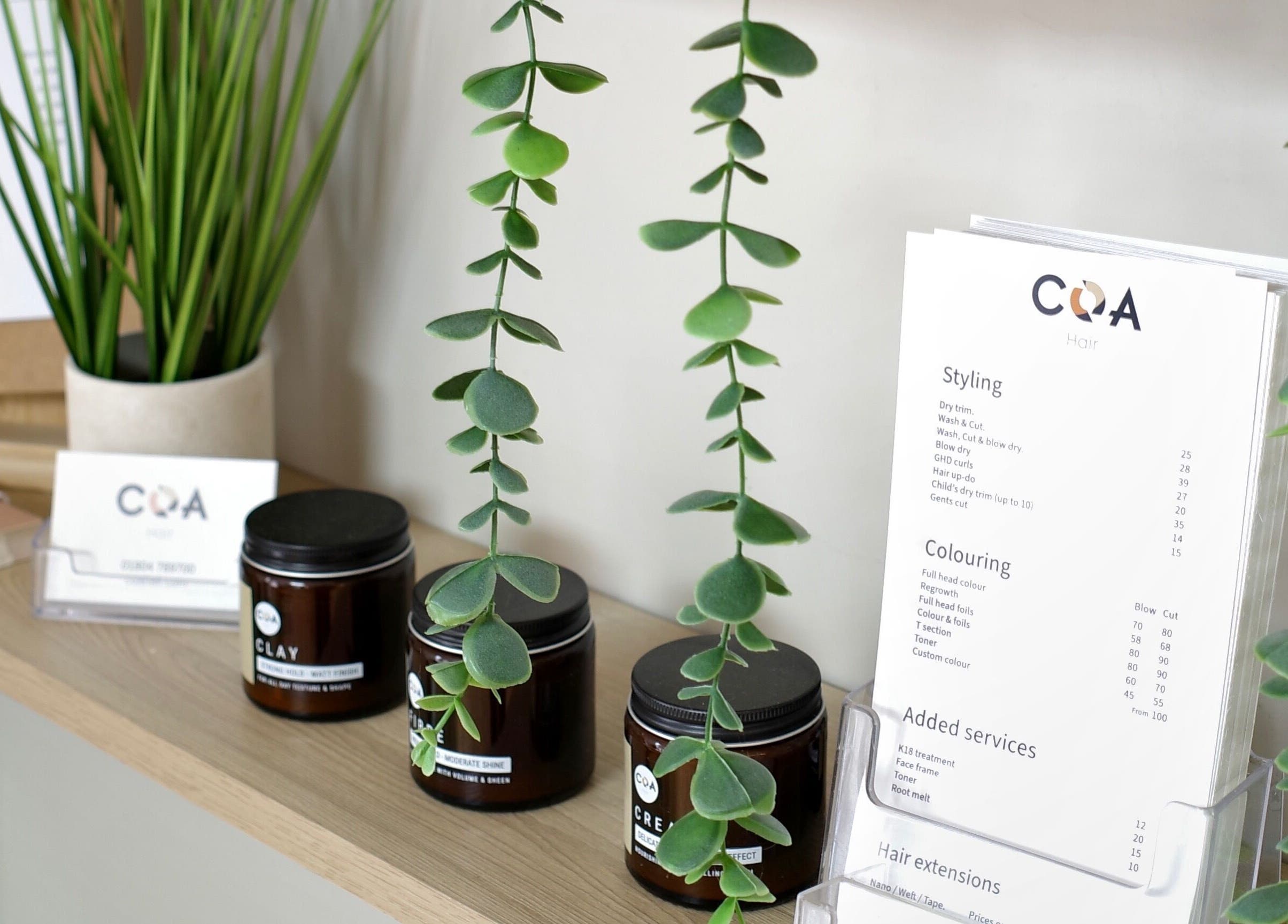 Elegant display at Coa Hair, York, England, GB with products and greenery enhancing the beauty and wellness atmosphere.