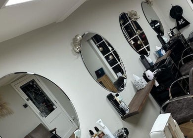 Interior of Coa Hair salon in York, England, GB, featuring modern styling chairs and mirrors.