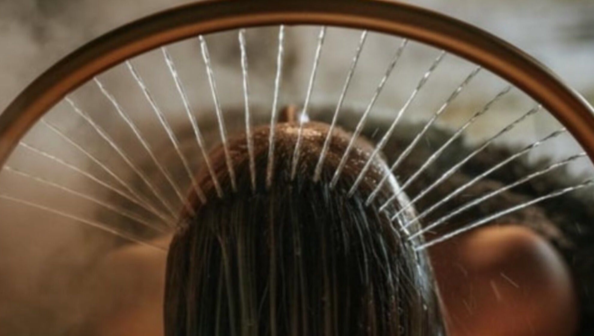 Water gracefully cascades on hair at Sakura Flow in Narborough, England, GB, offering a serene spa experience.