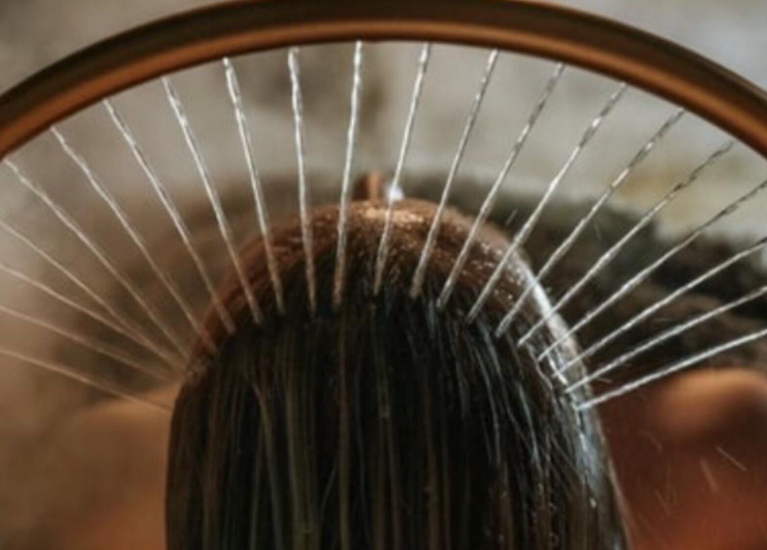 Water gracefully cascades on hair at Sakura Flow in Narborough, England, GB, offering a serene spa experience.