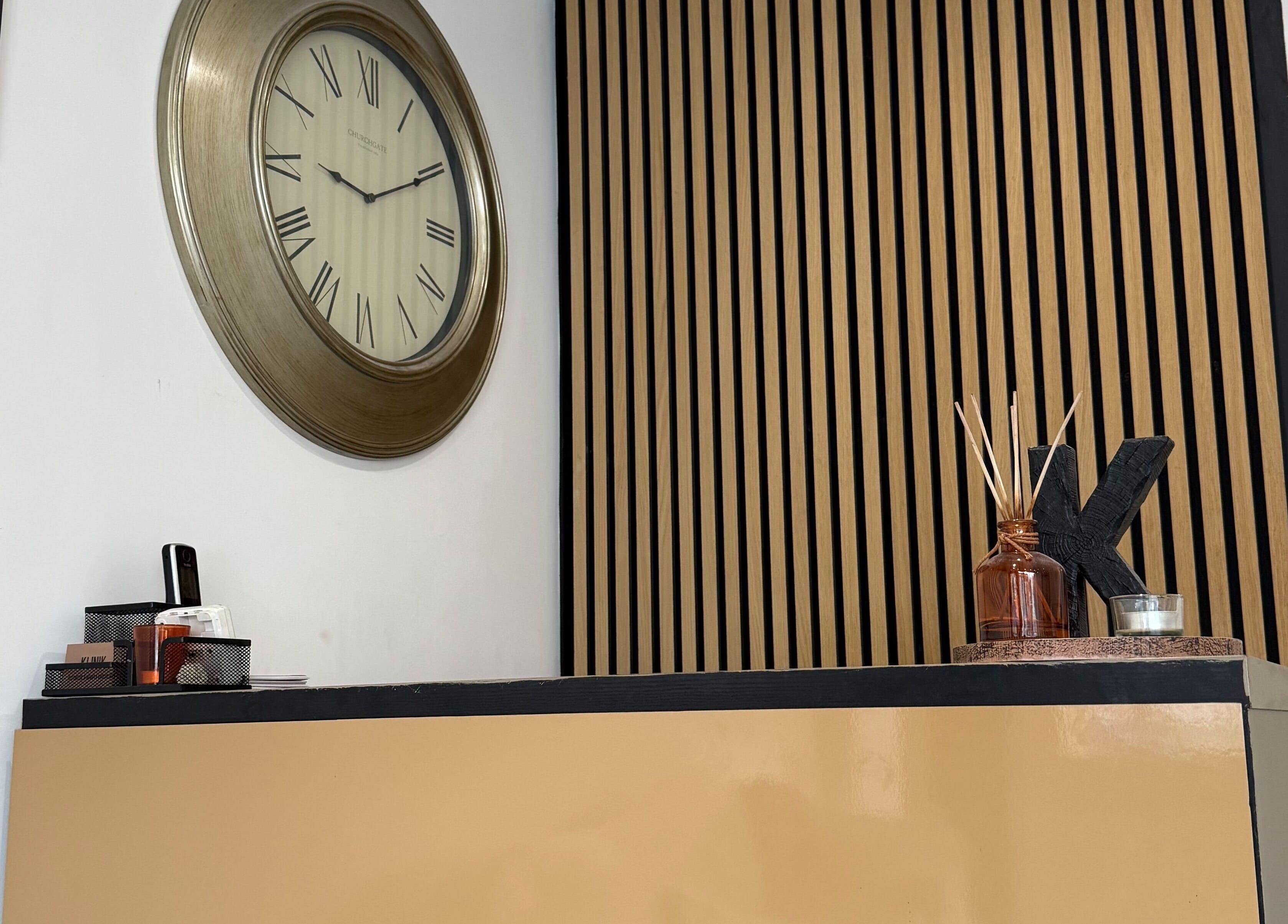 Reception area at Hair by Tyarna, Klinik with clock and decor, Balsall Common, England, GB.