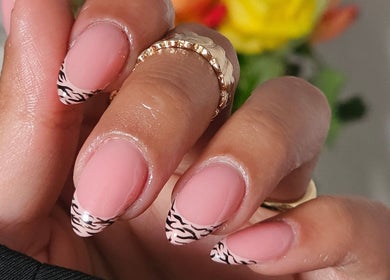 Close-up of zebra nail art at The Glow Way - TGW, Bedford, England, GB showcasing elegant manicure style.