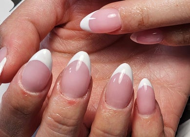 Elegant French manicure at The Glow Way - TGW in Bedford, England, GB. Perfectly polished for a chic style.