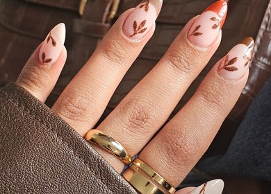Stylish nail art showcasing intricate leaf designs at The Glow Way - TGW, Bedford, England, GB.