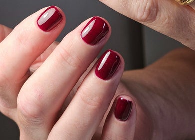 Close-up of expertly manicured red nails at The Glow Way - TGW, Bedford, England, GB.